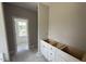 Bathroom with modern, white vanity and hardware with unfinished flooring and a view into the bathroom at 2776 Rains Mill Rd, Princeton, NC 27569
