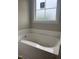 Bathroom with a large tub next to a frosted window at 2776 Rains Mill Rd, Princeton, NC 27569