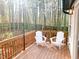Relaxing back deck surrounded by bamboo with white Adirondack chairs at 2907 University Dr, Durham, NC 27707