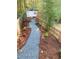 A stone walkway lined with mulch leads through a private backyard at 2907 University Dr, Durham, NC 27707