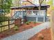 Large backyard with a blue deck, landscaping, and stone pathway at 2907 University Dr, Durham, NC 27707