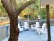 Blue deck with white Adirondack chairs and surrounded by gorgeous green landscape at 2907 University Dr, Durham, NC 27707