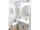 Bright bathroom with updated fixtures, round mirror, and vanity at 2907 University Dr, Durham, NC 27707