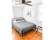 Cozy bedroom features hardwood floors, a ceiling fan, and natural light at 2907 University Dr, Durham, NC 27707
