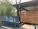 Charming house featuring a partially covered blue deck, a privacy wall, and lovely landscaping at 2907 University Dr, Durham, NC 27707