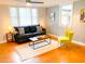 Bright living room with hardwood floors, large windows, and stylish furniture at 2907 University Dr, Durham, NC 27707