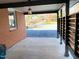 Covered outdoor patio featuring new concrete, wood slat privacy wall, and overhead lighting at 2907 University Dr, Durham, NC 27707