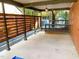Spacious covered patio with a wood slat privacy wall and view to the deck at 2907 University Dr, Durham, NC 27707