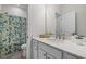 Bathroom featuring white vanity with quartz countertop and shower with floral shower curtain at 3053 Roy Ct, Apex, NC 27523