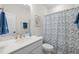 Bright bathroom with a single sink, floral shower curtain, and white cabinets at 3053 Roy Ct, Apex, NC 27523