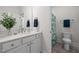 Bathroom featuring white vanity with modern fixtures and a shower with floral shower curtain at 3053 Roy Ct, Apex, NC 27523