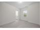 Bright bedroom featuring neutral walls and carpet, a window, and an ensuite bathroom at 3053 Roy Ct, Apex, NC 27523