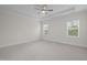 Bright bedroom with a tray ceiling and windows at 3053 Roy Ct, Apex, NC 27523