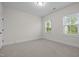 Bedroom with carpet flooring, neutral walls, and two windows at 3053 Roy Ct, Apex, NC 27523