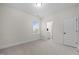 Empty bedroom featuring neutral carpet, paint and an entrance to the ensuite bathroom at 3053 Roy Ct, Apex, NC 27523