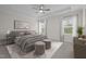 Primary bedroom features a tray ceiling, a king bed, and two windows at 3053 Roy Ct, Apex, NC 27523
