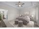 Well-lit bedroom with a tray ceiling and neutral decor at 3053 Roy Ct, Apex, NC 27523