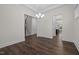 Open dining space with hardwood floors, a decorative chandelier, and lots of natural light at 3053 Roy Ct, Apex, NC 27523