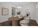 Bright dining area features hardwood floors, decorative chandelier, and neutral accents at 3053 Roy Ct, Apex, NC 27523