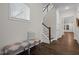 Inviting entryway with dark wood floors, staircase, and a bench seat under a window, creating a warm welcome at 3053 Roy Ct, Apex, NC 27523