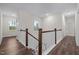 Hallway featuring wood floors and a white railing overlooking the street at 3053 Roy Ct, Apex, NC 27523