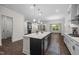 Bright, open-concept kitchen with stainless steel appliances, dark wood floors, and eat-in area at 3053 Roy Ct, Apex, NC 27523