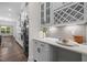 Kitchen area with white cabinets, stainless steel appliances, countertop decor and modern lighting at 3053 Roy Ct, Apex, NC 27523