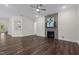 Spacious living room with dark hardwood floors, fireplace, and modern ceiling fan at 3053 Roy Ct, Apex, NC 27523