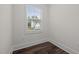 Empty room featuring a window and wood flooring at 3053 Roy Ct, Apex, NC 27523