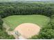 Aerial view of a well-maintained baseball field surrounded by lush greenery, perfect for outdoor activities at 308 Trappers Sack Rd, Cary, NC 27513
