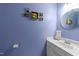 Charming powder room features a sink with storage and cheerful fish-themed artwork at 308 Trappers Sack Rd, Cary, NC 27513