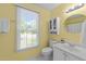 Bathroom with a window, white vanity, toilet, and a mirror, showcasing a clean and functional design at 308 Trappers Sack Rd, Cary, NC 27513