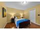 Bedroom with hardwood floors, a comfortable bed, side tables with lamps, and a window offering natural light at 308 Trappers Sack Rd, Cary, NC 27513