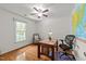 Bedroom with hardwood floors, ceiling fan, work desk and chair, and a large window letting in plenty of natural light at 308 Trappers Sack Rd, Cary, NC 27513
