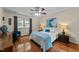 Bedroom with hardwood floors, a bed, and side tables with lamps, offering a cozy and inviting atmosphere at 308 Trappers Sack Rd, Cary, NC 27513