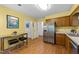Bright kitchen with stainless steel appliances, wooden cabinets and a breakfast bar with seating at 308 Trappers Sack Rd, Cary, NC 27513