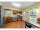 Well-lit kitchen featuring stainless steel appliances, wooden cabinets, and light-colored walls at 308 Trappers Sack Rd, Cary, NC 27513