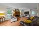 Inviting living room with a traditional brick fireplace, hardwood floors and large windows at 308 Trappers Sack Rd, Cary, NC 27513