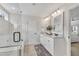 Bright bathroom featuring double vanity, granite counters, decorative mirrors and glass enclosed tub at 3181 Zebroid Way, New Hill, NC 27562