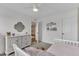 Bedroom features a white dresser, single bed, carpet and a quatrefoil mirror at 3181 Zebroid Way, New Hill, NC 27562