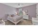 Cozy bedroom with a ceiling fan, neutral carpet, a window with natural light, and a decorated white frame bed at 3181 Zebroid Way, New Hill, NC 27562