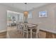Bright dining area with stylish pendant light fixture and large windows at 3181 Zebroid Way, New Hill, NC 27562