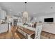 Open dining area with modern light fixture and view of the living room at 3181 Zebroid Way, New Hill, NC 27562