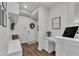 A cozy entryway features a built-in bench, coat hooks, and a desk with white cabinets at 3181 Zebroid Way, New Hill, NC 27562