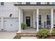Inviting front porch featuring rocking chairs and a hanging plant by the front door at 3181 Zebroid Way, New Hill, NC 27562