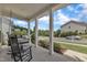 Cozy front porch with rocking chairs, a porch swing, and well-kept landscaping at 3181 Zebroid Way, New Hill, NC 27562