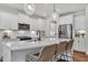 Beautiful kitchen with white cabinets, stainless steel appliances, and island with counter seating at 3181 Zebroid Way, New Hill, NC 27562