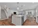 Modern kitchen featuring a center island, stainless steel appliances, and open layout at 3181 Zebroid Way, New Hill, NC 27562