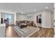 Cozy living room area with a comfortable sectional sofa and stylish patterned rug at 3181 Zebroid Way, New Hill, NC 27562
