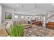 View of the living room with hardwood floors, ample seating, and ceiling fan at 3181 Zebroid Way, New Hill, NC 27562